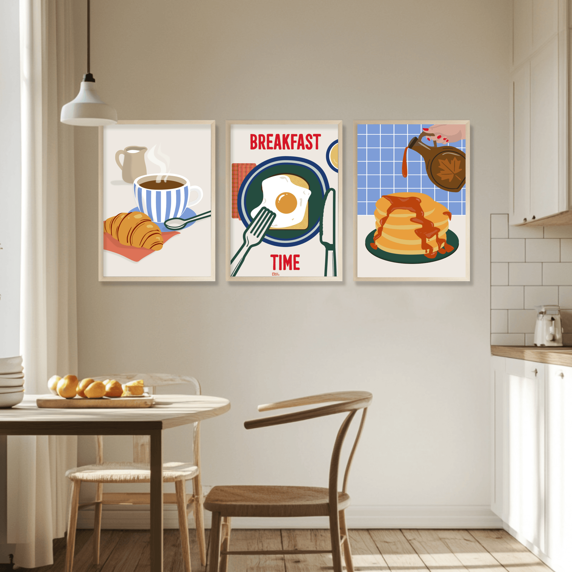 Cozy kitchen with framed breakfast art featuring coffee, croissant, eggs, and pancakes, enhancing morning vibes.